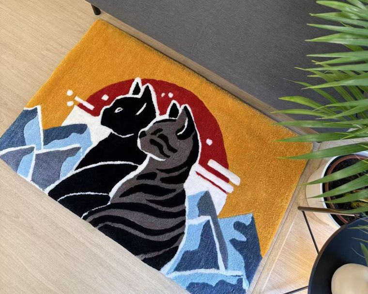 A rug with two cats in blocks of colour, in a customer living room.