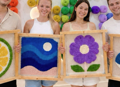 Travellers creating handmade tufted rugs together in Barcelona
